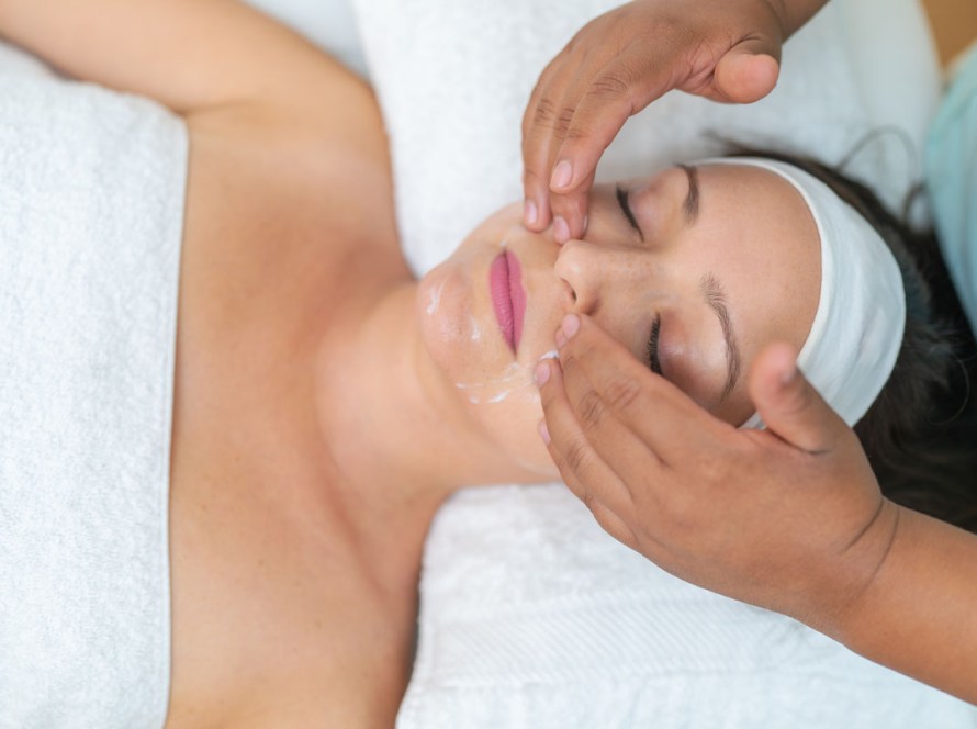 Client receiving the PB Glow Up in Pacific Beach, including a customized facial, red light face treatment, and full-body red light therapy session