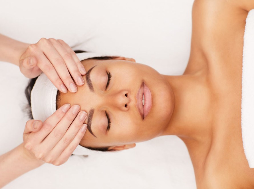 Client enjoying the Ocean Radiance Ritual spa package in Pacific Beach featuring a massage with organic aromatherapy, a customized facial, and a red light face treatment
