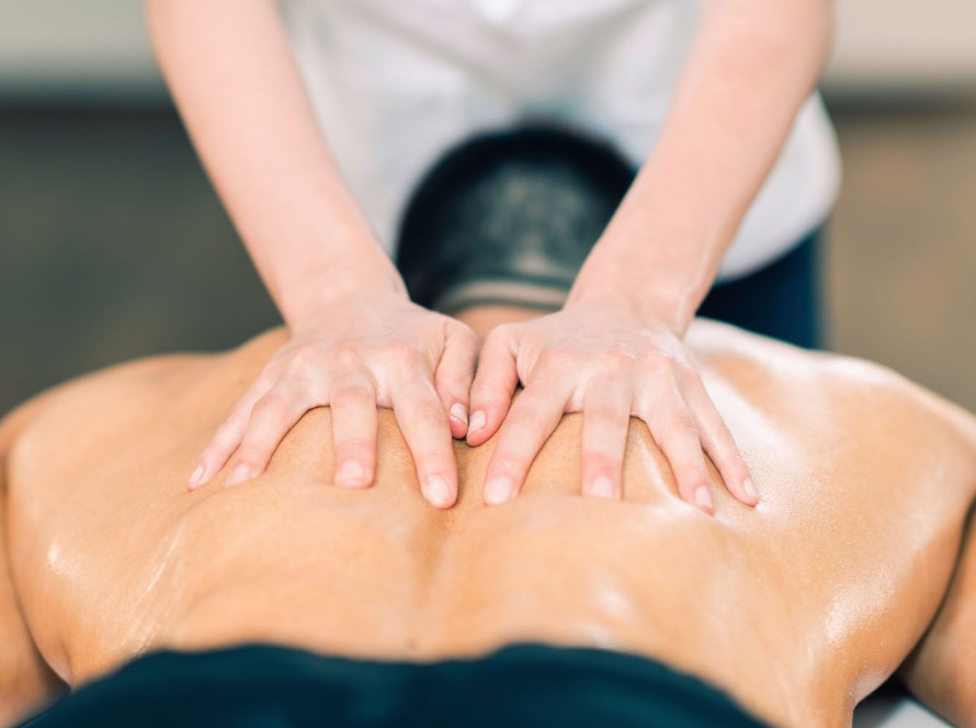 Athlete receiving a sports massage to aid recovery and improve performance at our Pacific Beach wellness center in San Diego