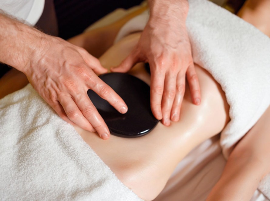 client enjoying the Coastal Detox and Renew spa package in Pacific Beach, San Diego, featuring lymphatic drainage massage, detox belly treatment, and full body red light therapy session