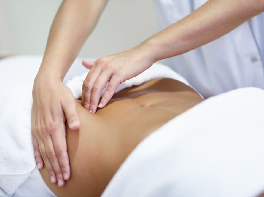 client receiving a gentle lymphatic drainage massage at a wellness center in Pacific Beach, San Diego.