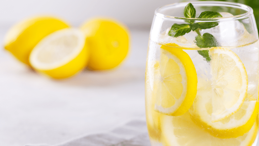 Glass of fresh lemon water on a sunlit table, symbolizing hydration and detox naturally in Pacific Beach.